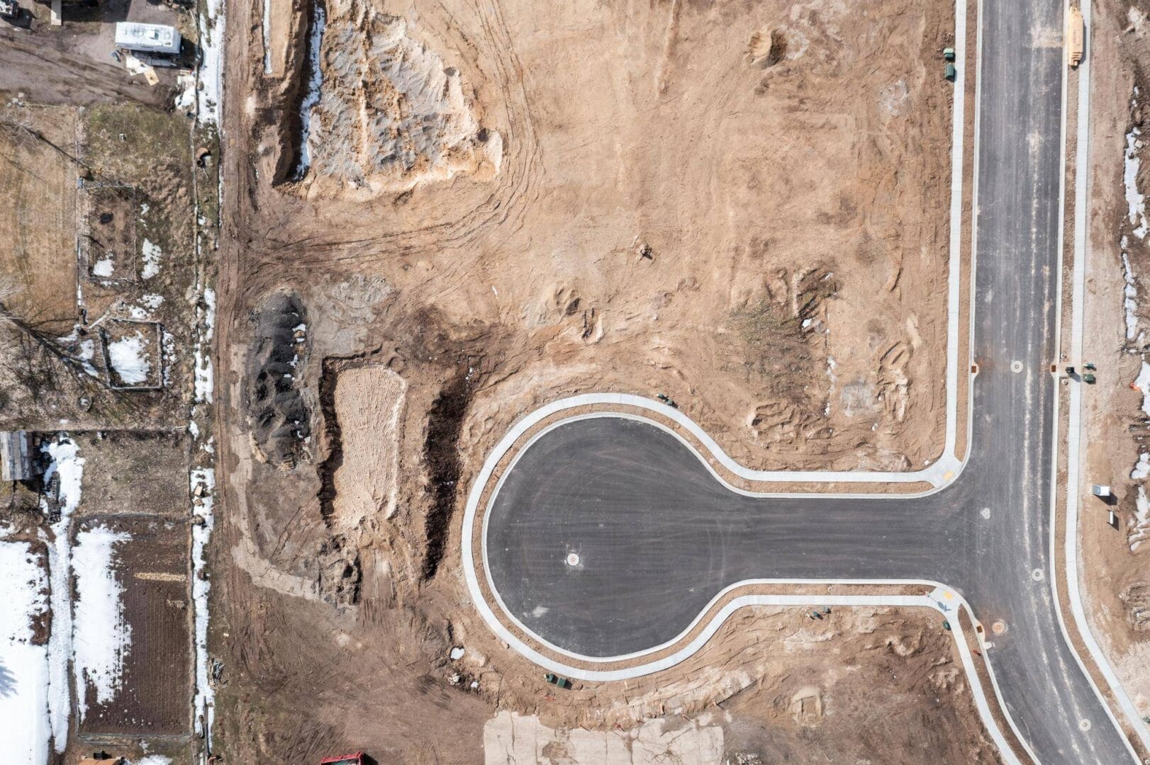 Aerial view of a construction site being developed by Riding Homes, a custom home builder in Southern Utah Valley.