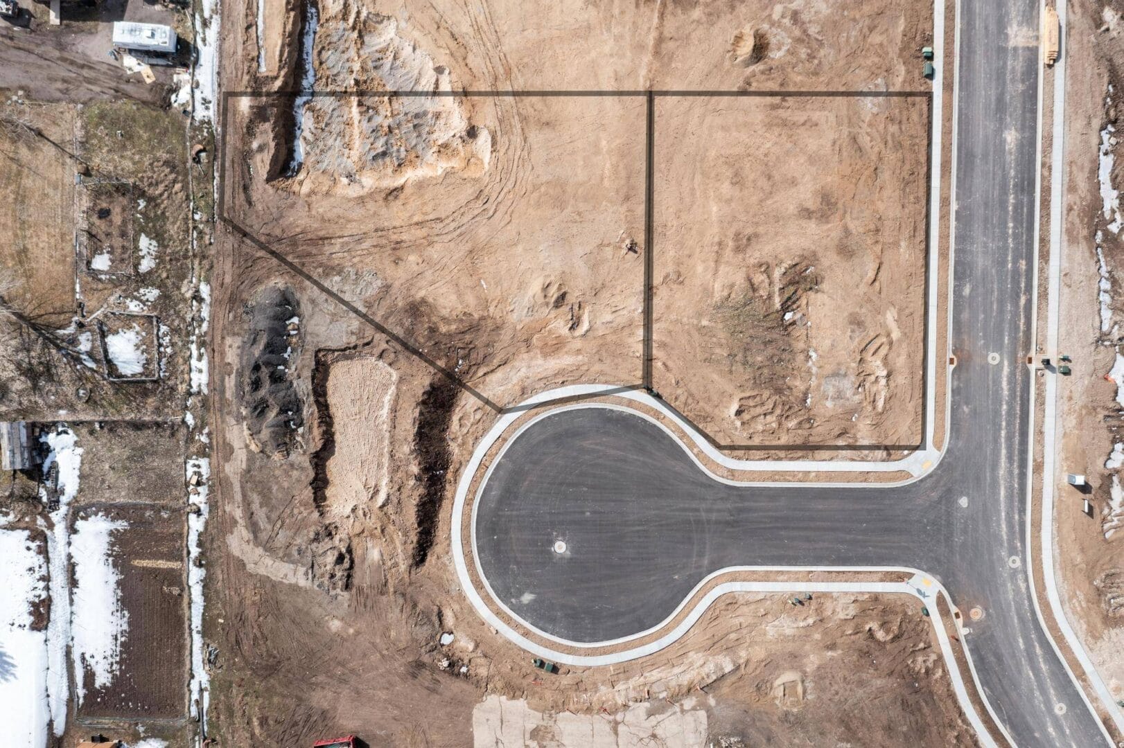 An aerial view of a custom home builder construction site in Southern Utah Valley