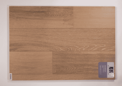 A picture of a wooden floor with a label on it, showcasing the exquisite craftsmanship of a Custom Home Builder.