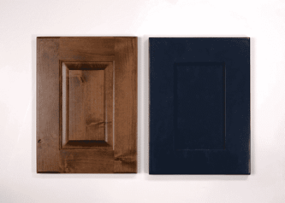 Two wooden cabinet doors on a white wall in a custom home.