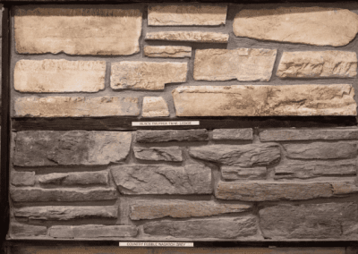 A stone wall with various types of stones, custom-built by Riding Homes in Southern Utah Valley.