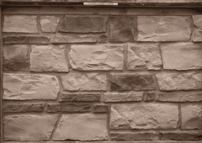 A photo of a stone wall in a custom frame by Riding Homes, showcasing their impeccable craftsmanship in Southern Utah Valley.