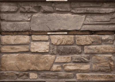 A picture of a stone wall in a frame by Riding Homes, a Custom Home Builder in Southern Utah Valley.