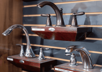 A display of bathroom faucets by Riding Homes on a wall in Southern Utah Valley.