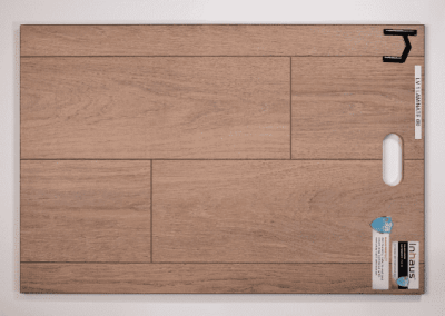 A wooden plank with a piece of paper on it, customized by a southern Utah Valley custom home builder.