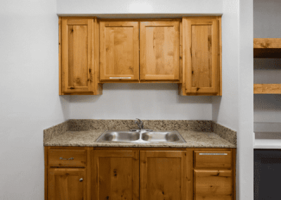 A small kitchen with custom wooden cabinets and a sink.