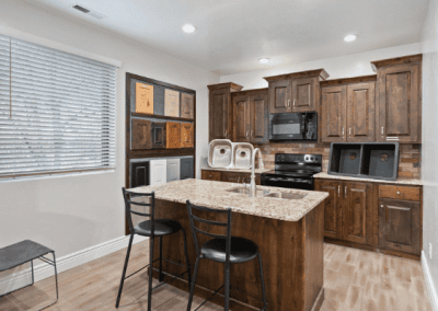 Riding Homes, a custom home builder in Southern Utah Valley, presents a kitchen with stunning wooden cabinets and counter tops.