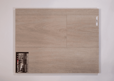 A picture of a wooden plank on a white wall, showcasing the craftsmanship of Riding Homes, a reputable custom home builder in Southern Utah Valley.