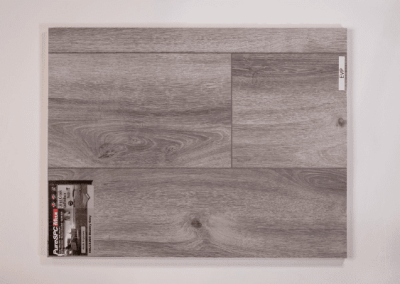 A picture of a grey wood plank on a white wall, captured by Riding Homes in Southern Utah Valley.