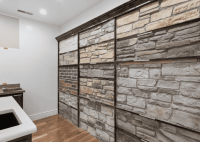 A Custom Home Builder in Southern Utah Valley creates a stunning room with a wall of stone and brick.
