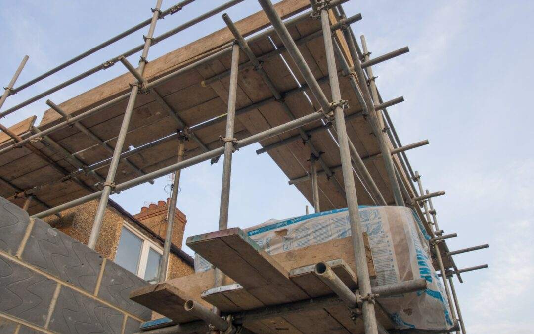 Southern Utah Valley Custom Home Builder, Riding Homes, erecting scaffolding on the roof of a building.