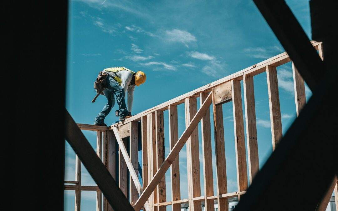 A construction worker employed by Riding Homes is currently working on a wooden frame for a custom home in Southern Utah Valley.