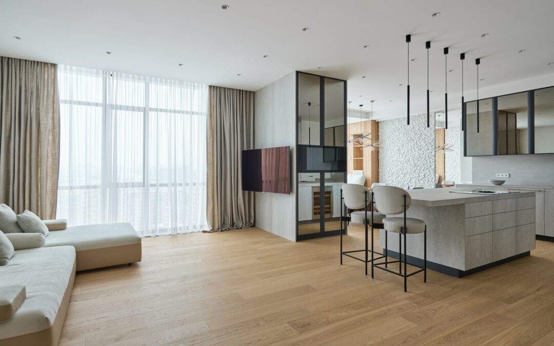 A modern apartment with wooden floors and a large kitchen, built by Riding Homes.