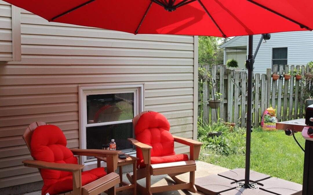 A red umbrella on a custom home builder's deck.